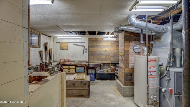 19 High St, Fort Plain, NY 13339 - unfinished basement with water heater, wood walls, and a workshop area
