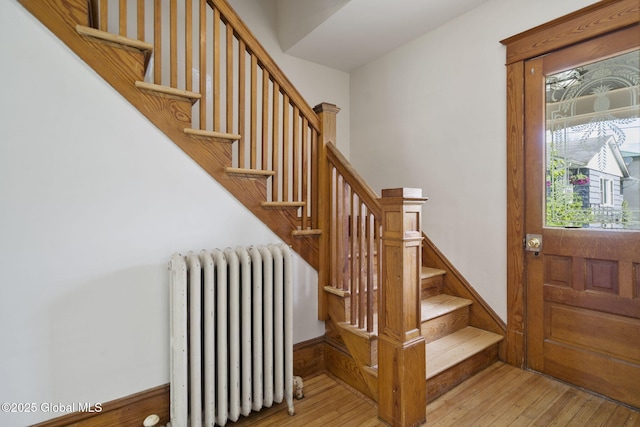 11 River St, Stamford, NY 12167 - foyer entrance featuring radiator heating unit, stairway, and hardwood / wood-style flooring