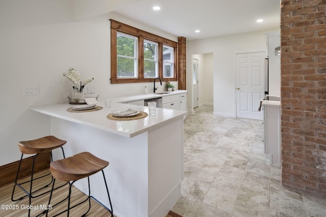 11 River St, Stamford, NY 12167 - kitchen with white cabinets, a breakfast bar, light countertops, a peninsula, and recessed lighting