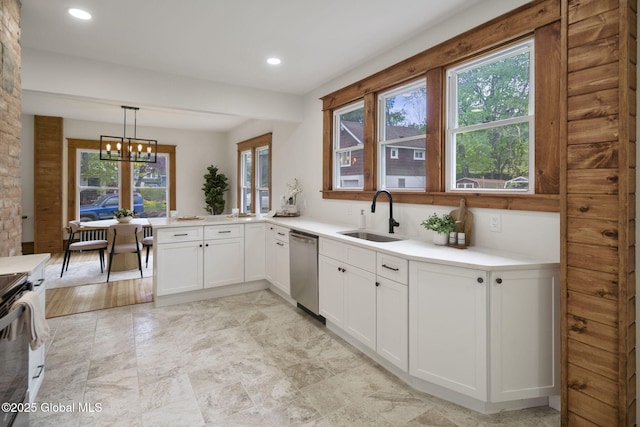11 River St, Stamford, NY 12167 - kitchen with stainless steel appliances, white cabinets, light countertops, a peninsula, and hanging light fixtures