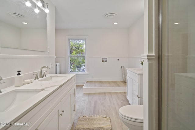 11 River St, Stamford, NY 12167 - bathroom with double vanity, wainscoting, wood finished floors, and a shower with shower door