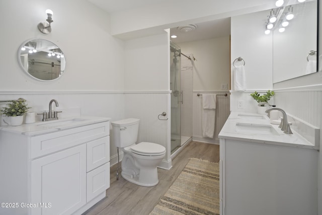 11 River St, Stamford, NY 12167 - full bathroom featuring double vanity, wood finished floors, a stall shower, and a wainscoted wall