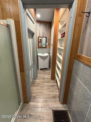 17 W St, Fort Plain, NY 13339 - corridor featuring light wood-style flooring and wood walls