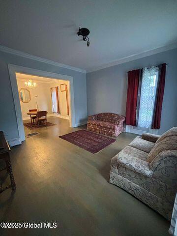 17 W St, Fort Plain, NY 13339 - living room with crown molding, a chandelier, and wood finished floors