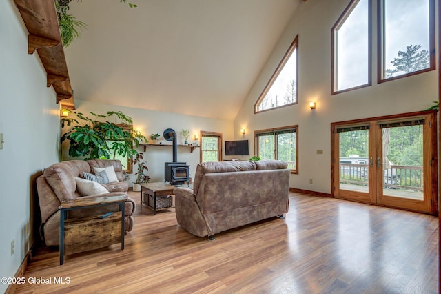349 Methodist Farm Rd, Sand Lake, NY 12018 - living room featuring a wood stove, high vaulted ceiling, and light wood-style floors