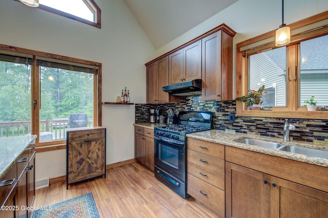 349 Methodist Farm Rd, Sand Lake, NY 12018 - kitchen featuring black range with gas stovetop, under cabinet range hood, decorative backsplash, lofted ceiling, and light wood-style floors