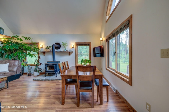 349 Methodist Farm Rd, Sand Lake, NY 12018 - dining area with a wood stove, light wood-style floors, and lofted ceiling