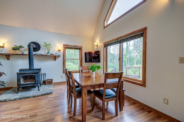 349 Methodist Farm Rd, Sand Lake, NY 12018 - dining room featuring wood finished floors, a wood stove, and high vaulted ceiling