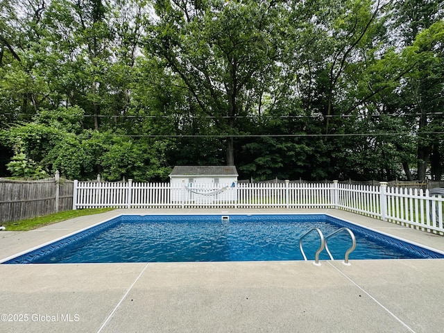 10 Spruce St, Hudson Falls, NY 12839 - view of pool featuring a fenced backyard, view of wooded area, and a patio