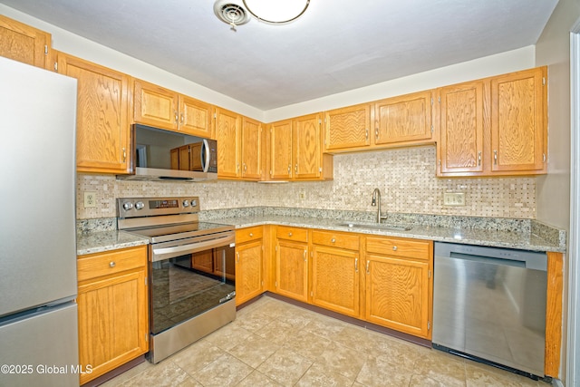 5 Bridgewood Ln, Watervliet, NY 12189 - kitchen with appliances with stainless steel finishes, tasteful backsplash, and light stone countertops