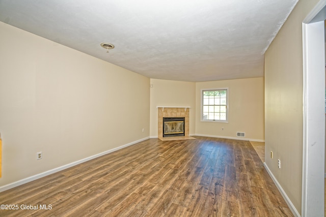 5 Bridgewood Ln, Watervliet, NY 12189 - unfurnished living room with wood finished floors and a tiled fireplace