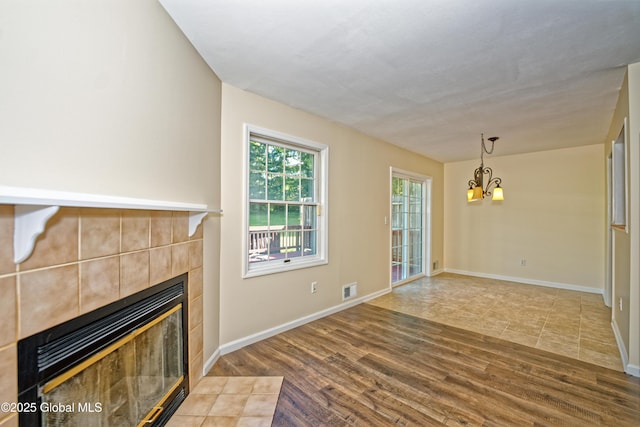 5 Bridgewood Ln, Watervliet, NY 12189 - unfurnished living room with a fireplace, a chandelier, and wood finished floors