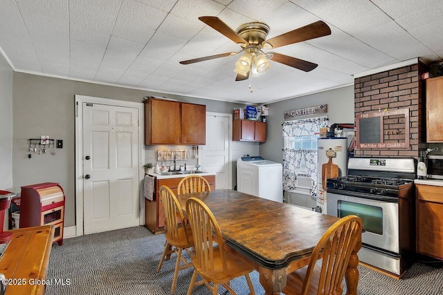 75-77 S 3rd St, Hudson, NY 12534 - kitchen with washer / clothes dryer, gas stove, ceiling fan, dark carpet, and water heater