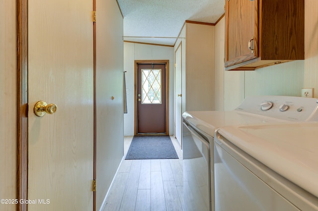 114 Burdick Rd, Johnstown, NY 12078 - laundry room with washing machine and dryer, ornamental molding, cabinet space, and light wood-style floors