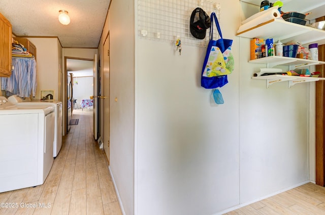 114 Burdick Rd, Johnstown, NY 12078 - laundry area featuring washer and clothes dryer, light wood finished floors, and a textured ceiling