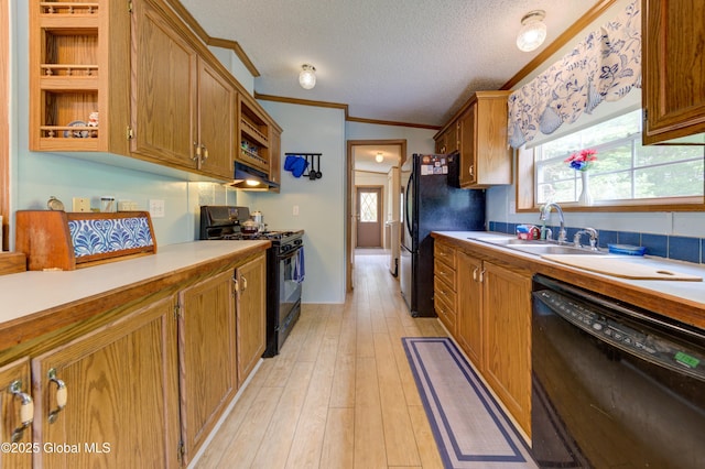 114 Burdick Rd, Johnstown, NY 12078 - kitchen featuring black appliances, ornamental molding, under cabinet range hood, light countertops, and a textured ceiling
