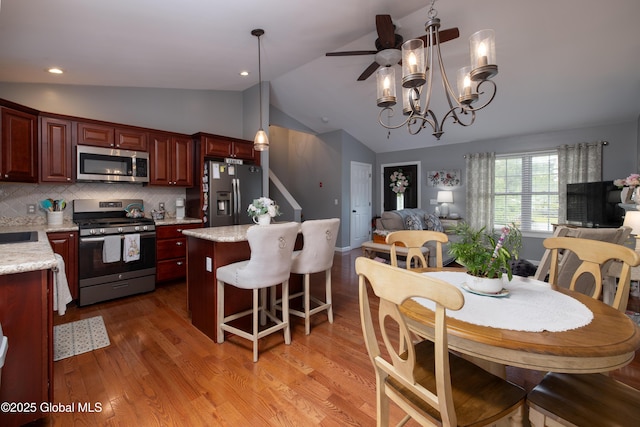 20 Quarry Circle Way, Kingsbury, NY 12839 - dining area with lofted ceiling, light wood finished floors, ceiling fan, and a chandelier