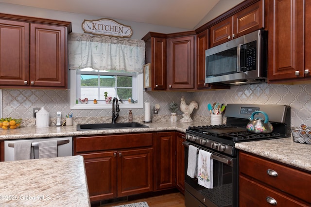 20 Quarry Circle Way, Kingsbury, NY 12839 - kitchen with appliances with stainless steel finishes, light countertops, vaulted ceiling, light wood finished floors, and tasteful backsplash