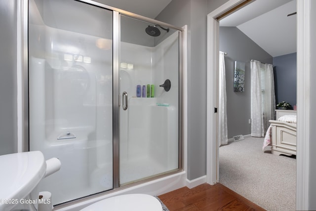20 Quarry Circle Way, Kingsbury, NY 12839 - bathroom with a stall shower, vaulted ceiling, and wood finished floors