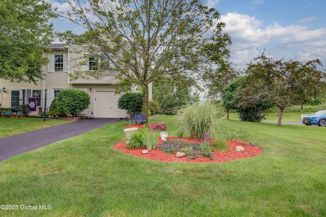 125 Bridgewood Ln, Colonie, NY 12189 - view of front of home featuring a garage, driveway, and a front lawn