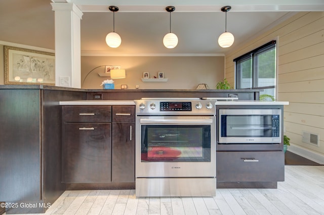 125 Bridgewood Ln, Colonie, NY 12189 - kitchen with appliances with stainless steel finishes, ornamental molding, dark brown cabinetry, light wood-style flooring, and hanging light fixtures