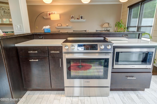 125 Bridgewood Ln, Colonie, NY 12189 - kitchen with stainless steel appliances, crown molding, dark brown cabinets, and light wood-style floors