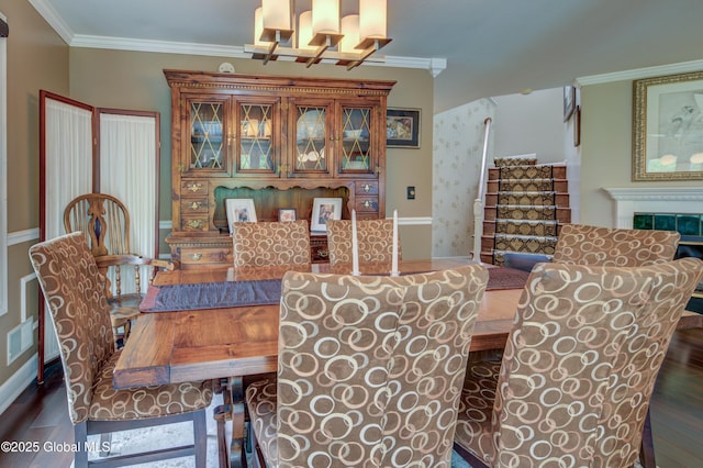 125 Bridgewood Ln, Colonie, NY 12189 - dining area featuring wood finished floors, a chandelier, crown molding, and a tiled fireplace