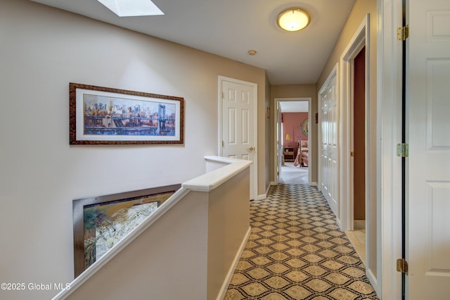 125 Bridgewood Ln, Colonie, NY 12189 - hallway with light floors, a skylight, and an upstairs landing
