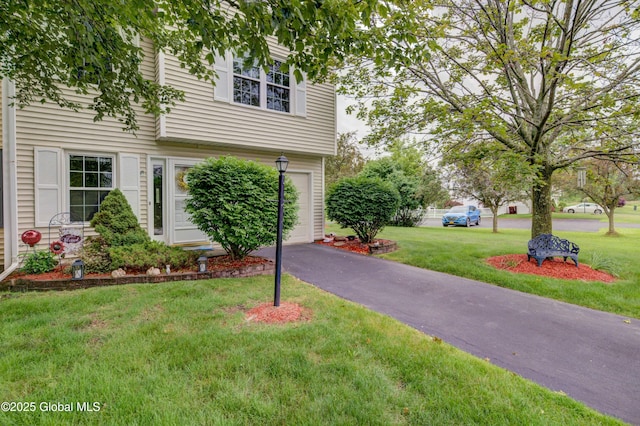 125 Bridgewood Ln, Colonie, NY 12189 - view of property exterior with a yard, asphalt driveway, and an attached garage