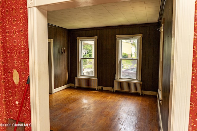 53 Broad St, Catskill, NY 12414 - empty room featuring radiator heating unit, wood finished floors, and ornamental molding