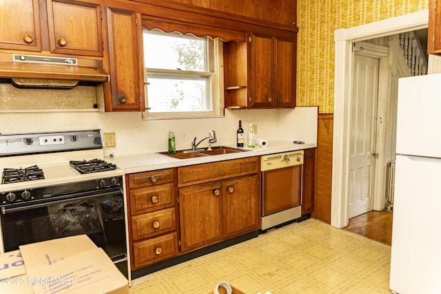 53 Broad St, Catskill, NY 12414 - kitchen with freestanding refrigerator, gas range, dishwasher, under cabinet range hood, and wallpapered walls