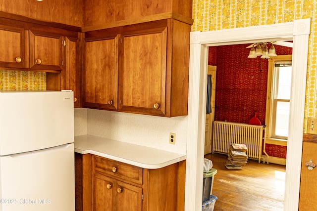 53 Broad St, Catskill, NY 12414 - kitchen featuring freestanding refrigerator, wallpapered walls, radiator, light countertops, and wood finished floors