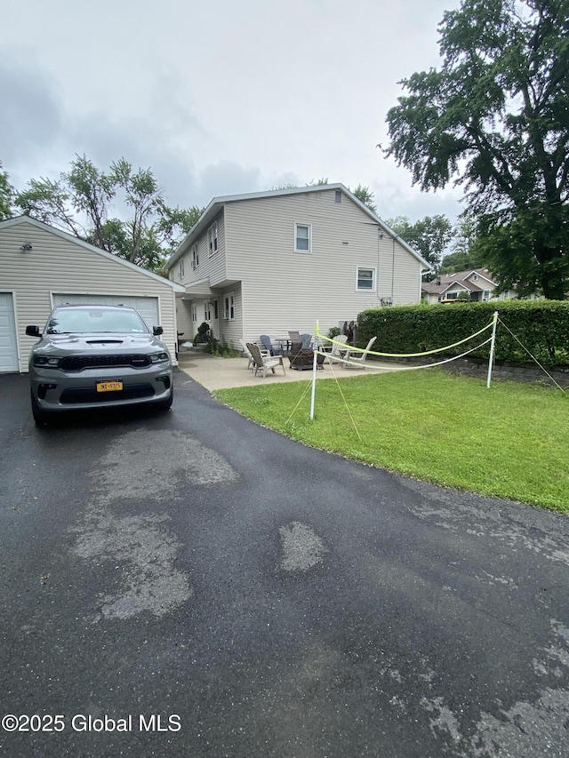 9 Brayton St, Colonie, NY 12205 - view of side of home with a yard, driveway, and a fire pit