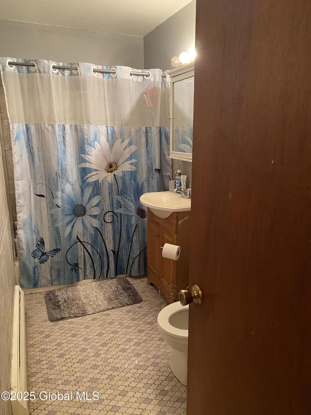 9 Brayton St, Colonie, NY 12205 - bathroom with vanity, baseboard heating, curtained shower, and tile patterned floors