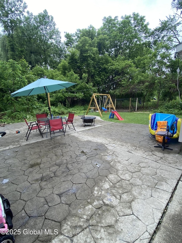 9 Brayton St, Colonie, NY 12205 - view of patio with a playground, an outdoor fire pit, and view of wooded area