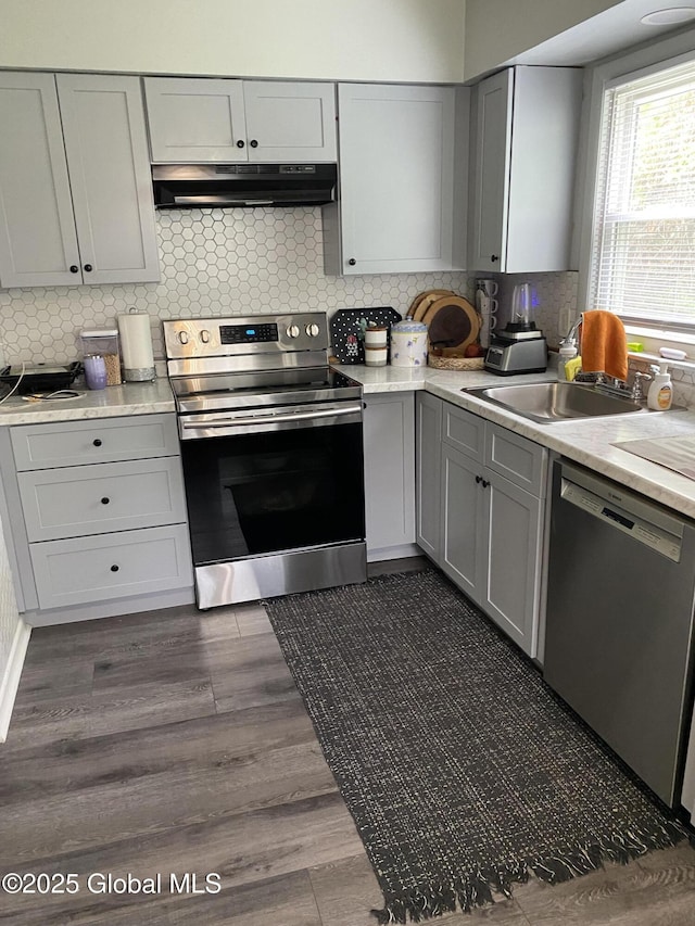 9 Brayton St, Colonie, NY 12205 - kitchen with stainless steel appliances, under cabinet range hood, gray cabinets, and light countertops