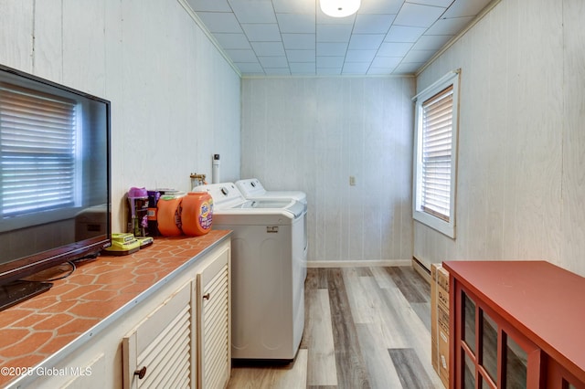 448 State Highway 334, Johnstown, NY 12095 - laundry room featuring washer and clothes dryer, light wood-style floors, cabinet space, and wooden walls