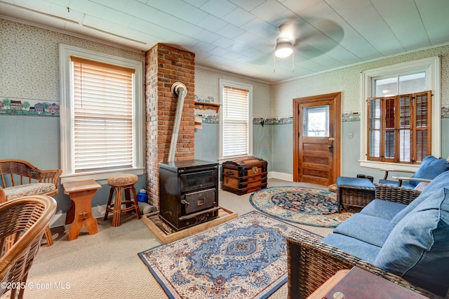 448 State Highway 334, Johnstown, NY 12095 - carpeted living area with a wood stove, ornamental molding, wallpapered walls, and a ceiling fan
