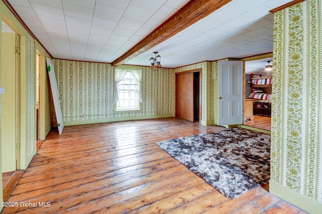 448 State Highway 334, Johnstown, NY 12095 - spare room with wallpapered walls, wood-type flooring, and beam ceiling