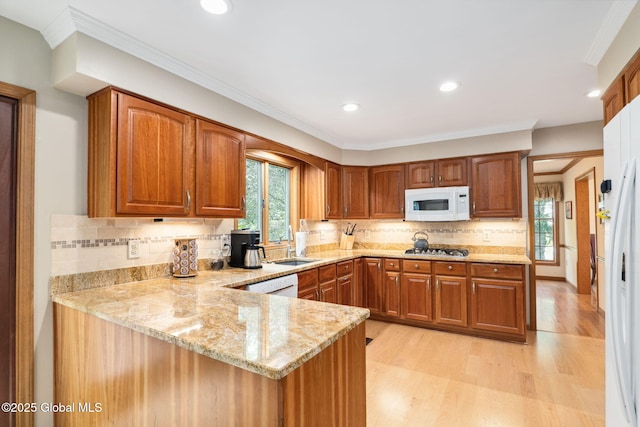 77 Rotterdam Dr, Bethlehem, NY 12077 - kitchen featuring white appliances, light stone countertops, light wood finished floors, brown cabinets, and recessed lighting