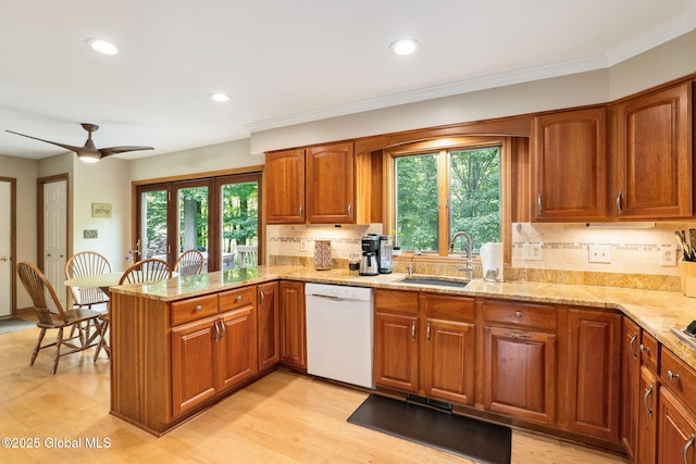 77 Rotterdam Dr, Bethlehem, NY 12077 - kitchen featuring dishwasher, light stone countertops, brown cabinetry, a peninsula, and tasteful backsplash