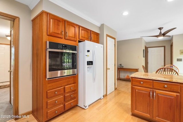77 Rotterdam Dr, Bethlehem, NY 12077 - kitchen featuring white refrigerator with ice dispenser, stainless steel oven, brown cabinetry, light wood-style flooring, and recessed lighting