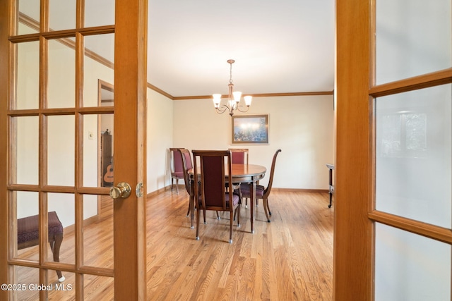 77 Rotterdam Dr, Bethlehem, NY 12077 - dining space with ornamental molding, a chandelier, light wood finished floors, and french doors