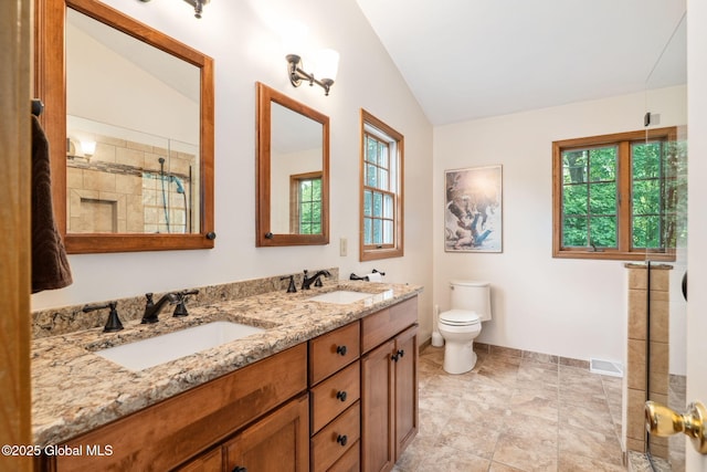 77 Rotterdam Dr, Bethlehem, NY 12077 - bathroom featuring lofted ceiling, double vanity, and a tile shower