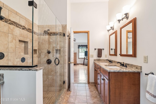 77 Rotterdam Dr, Bethlehem, NY 12077 - bathroom with a tile shower, double vanity, and tile patterned floors