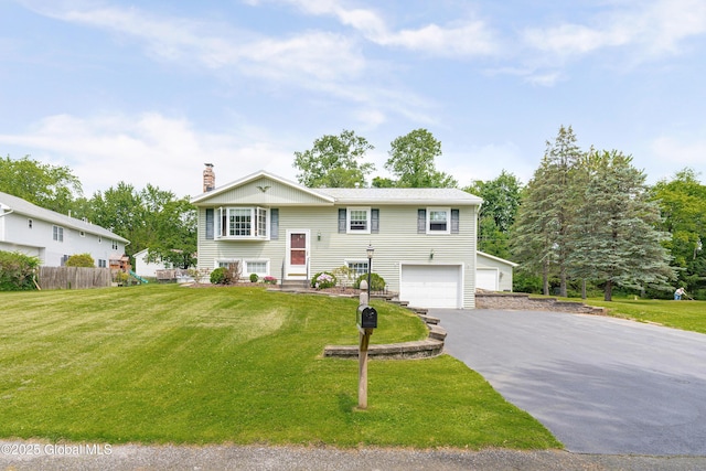 47 Comely Ln, Colonie, NY 12110 - bi-level home with driveway, an attached garage, and a chimney
