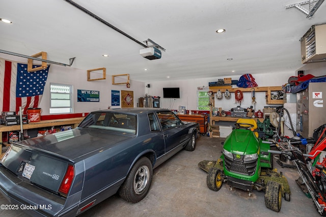 47 Comely Ln, Colonie, NY 12110 - garage featuring a garage door opener, recessed lighting, a workshop area, and a heating unit