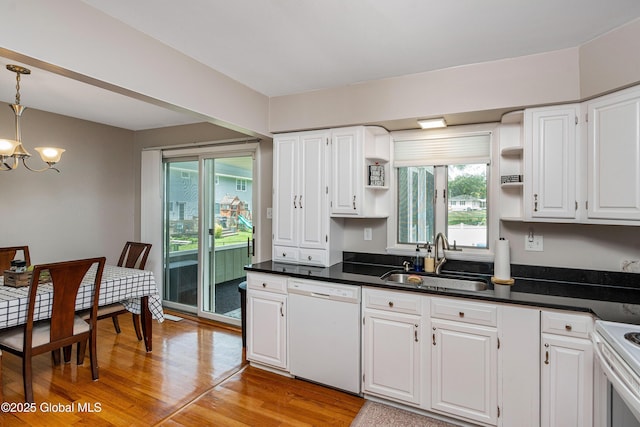 47 Comely Ln, Colonie, NY 12110 - kitchen with white appliances, a chandelier, white cabinets, light wood-style floors, and dark countertops