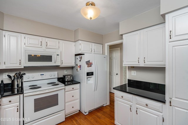 47 Comely Ln, Colonie, NY 12110 - kitchen with white appliances, dark countertops, white cabinets, and light wood finished floors