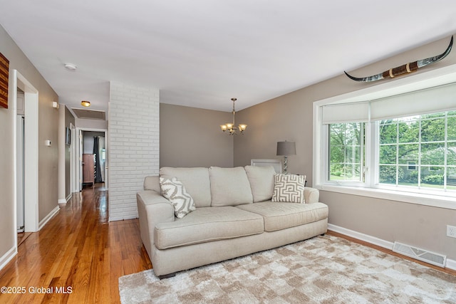 47 Comely Ln, Colonie, NY 12110 - living area featuring healthy amount of natural light, wood finished floors, and a chandelier